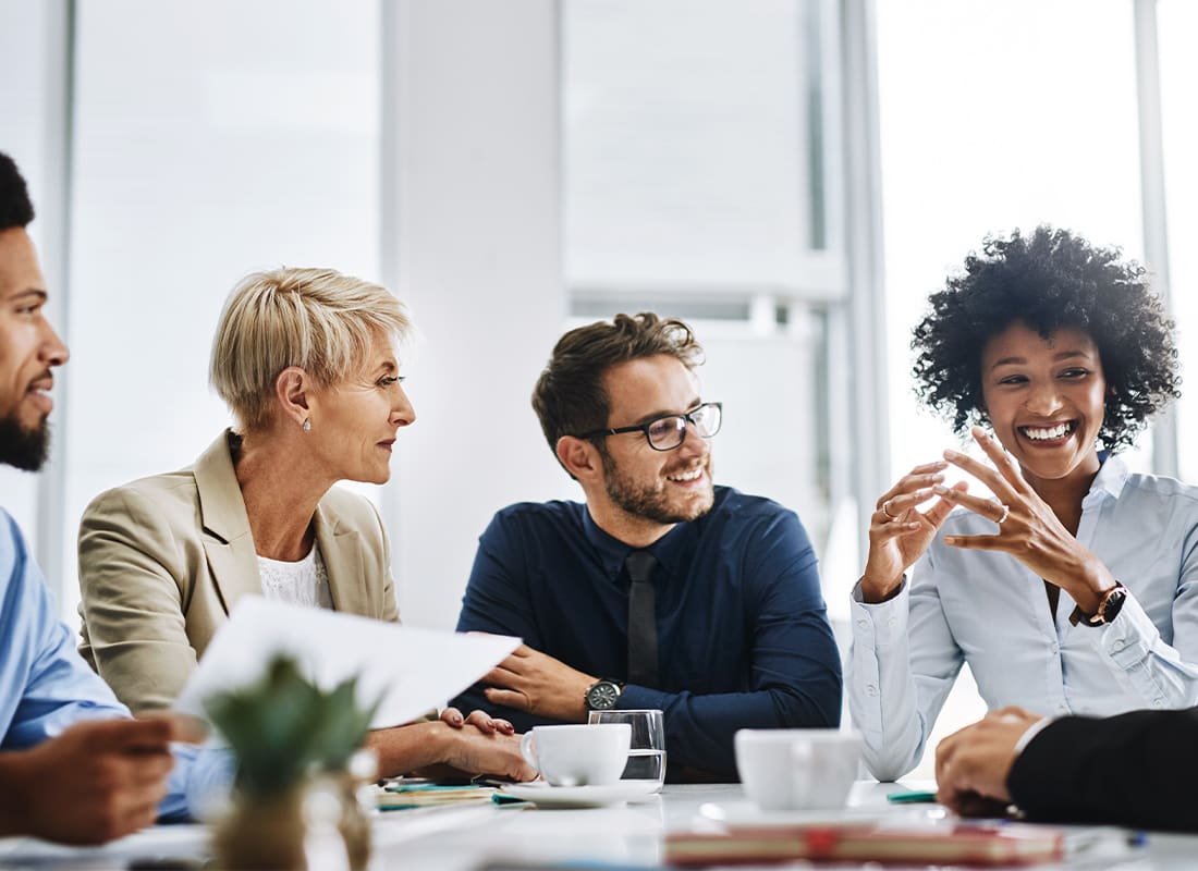 About Our Agency - With the Help of the Whole Team, Anything is Possible. Shot of a Group of Businesspeople Sitting Together in a Meeting